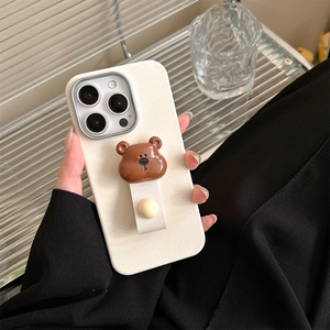 Detail of cream white iPhone case with 3D brown bear and leather hand strap attachment