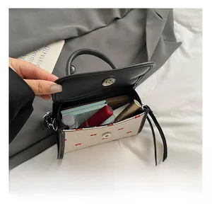 Interior view showing capacity of bow-knot crossbody bag for lipstick and makeup
