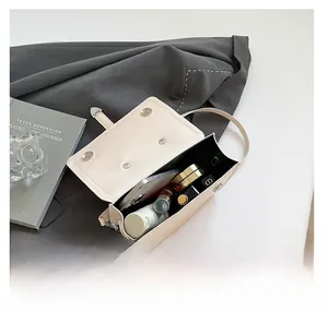 Minimalist beige crossbody bag showing spacious interior for phone and cosmetics
