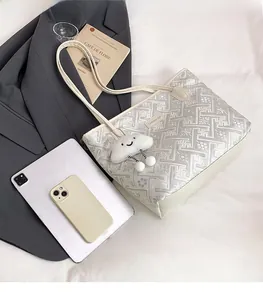 Ethnic pattern tote bag with plush cloud charm shown next to a tablet for size reference