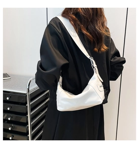 Detailed back view of a white leather half-moon shoulder bag with wide strap and silver buckle