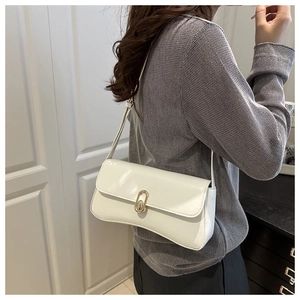 Detailed side view of white baguette shoulder bag with gold oval buckle on model