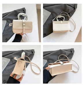 Detail view of cream leather crossbody bag with liquid metal handle and V-weave texture