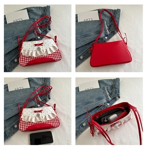 Detail view of the red and white contrast bag showing interior storage and ruffles