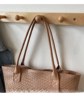Detail of woven texture and reinforced shoulder strap on large retro tote bag