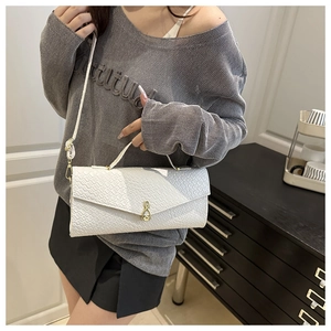 White woven texture shoulder bag worn by model showing size and elegant drape