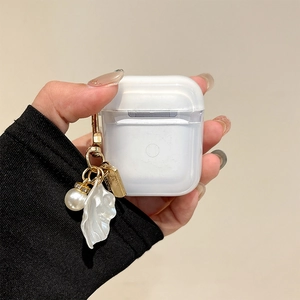 Detail view of transparent earphone case featuring a white leaf and pearl charm attachment