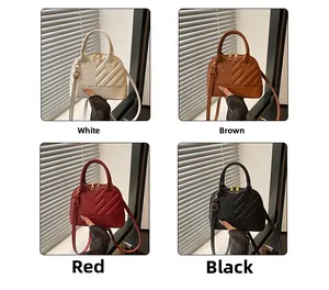 Detailed view of quilted shell bags in white, brown, red, and black with gold zippers