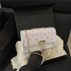 Floral print square crossbody bag with gold chain strap on premium gift packaging