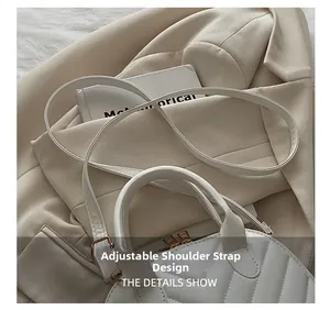 Detail showing adjustable strap and V-quilted texture on white faux leather shell bag