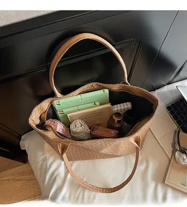 Interior view of brown woven tote bag showing large capacity for laptop and daily items
