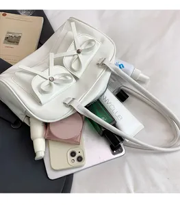 White PU leather bag showing spacious interior with phone, makeup, and tablet storage