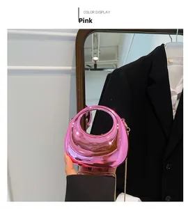 Detailed view of pink crescent moon bag with glossy mirror finish and gold chain strap