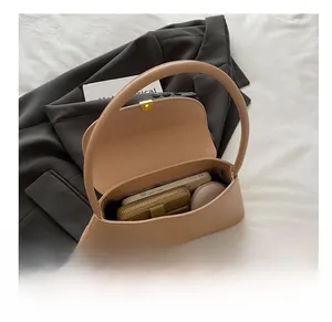Interior view of beige leather shoulder bag showing capacity for phone and wallet