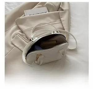 Internal capacity view of white quilted crossbody bag showing daily essentials storage