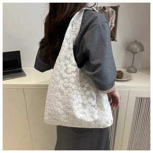 Detail of white lace floral embroidery on large capacity casual tote bag for women