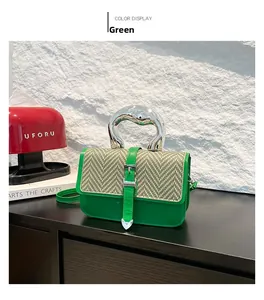 Detail of green leather handbag with woven flap and artistic silver metal handle
