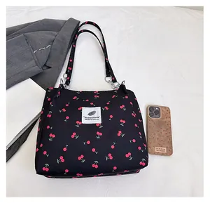 Detailed view of black cherry print tote bag showing fabric texture and capacity