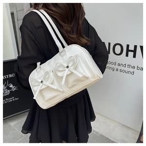 Chic cream white PU leather bag detail featuring dual front pockets and stylish bows
