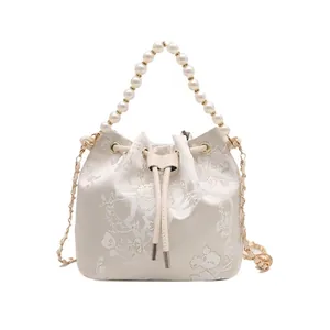 White jacquard bucket bag with floral embroidery and elegant faux pearl handle straps