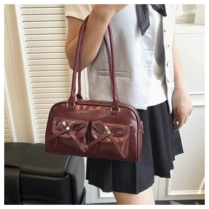 Deep burgundy shoulder bag with front pocket bows and silver hardware detail