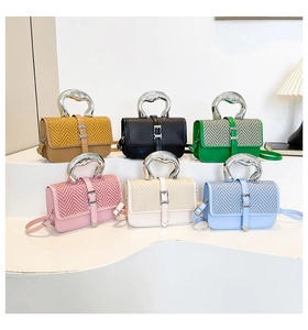 Minimalist square handbags in diverse colors with textured flaps and unique metal handles