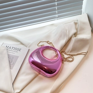 Metallic pink crescent evening bag with gold chain and cutout handle for summer style