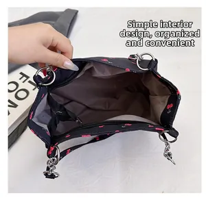 Detail view of the cherry print tote bag interior with gray lining and zipper closure