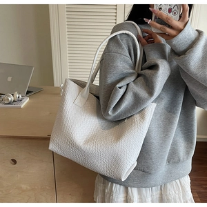 Detail showing the white woven texture and large capacity of this retro tote shoulder bag
