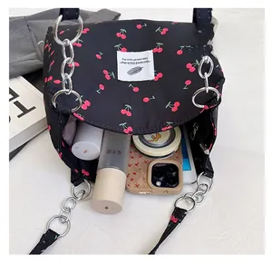 Detail of cherry print tote bag showing spacious interior with tablet and cosmetics