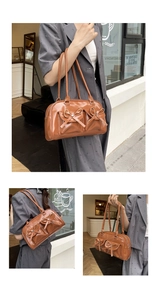 Detail of a brown PU leather shoulder bag featuring ribbon bows and twin front pockets