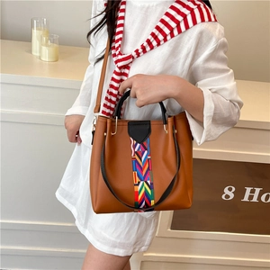 Brown vintage tote bag with colorful ethnic woven strap for summer stylish women