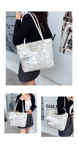 Macro shot of white woven texture tote bag with plush cloud charm and metal logo