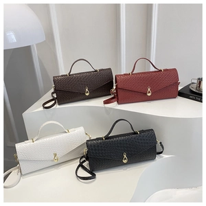 Multiple woven texture handbags in brown, red, white, and black with gold hardware