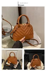 Detailed view of a brown shell bag featuring V-shaped quilting and golden metal hardware