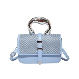 Chic light blue crossbody bag with herringbone weave flap and silver wave handle