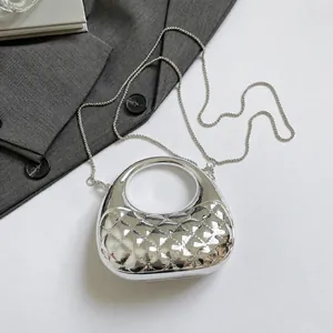 Macro detail of silver diamond lattice pattern acrylic bag with metal chain