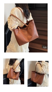 Detail view of large brown woven leather tote bag with vintage texture and slim straps