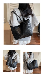 Close-up of black woven texture on large tote bag with elegant handles for daily use
