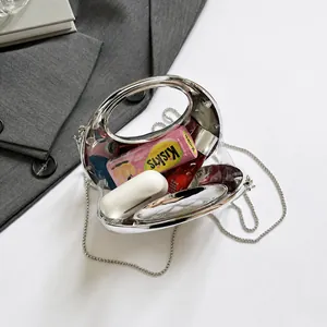 Detail view showing capacity of transparent acrylic handbag with silver chain and handle
