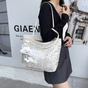 Silver tote bag with geometric texture and cute plush charm for casual daily commuting
