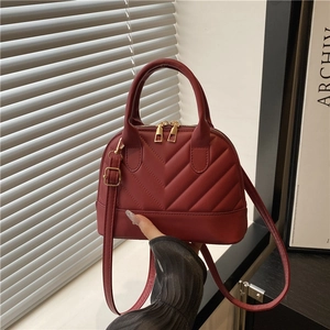 Elegant wine red quilted shell handbag with golden zipper and detachable shoulder strap