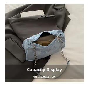 Detailed view of the light blue floral baguette bag showing its interior capacity.