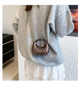 Detail of coffee acrylic mini bag featuring diamond quilted texture and crystal studs