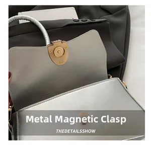 Detail of silver metallic textured square bag showing the magnetic snap closure mechanism