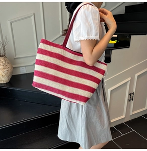 Detail of red and white striped woven tote bag with thick rope straps for daily use