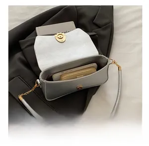 Internal view of silver sequin shoulder bag showing capacity for smartphone and wallet
