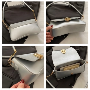 Detail view of silver square crossbody bag interior showing space for phone and wallet