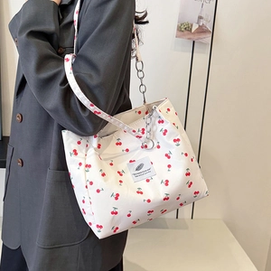 White cherry print tote bag with silver chain straps and fresh floral patterns