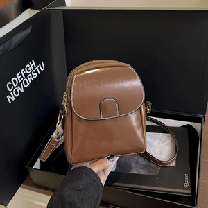 Brown glossy leather crossbody bag with double zippers in a premium gift box set